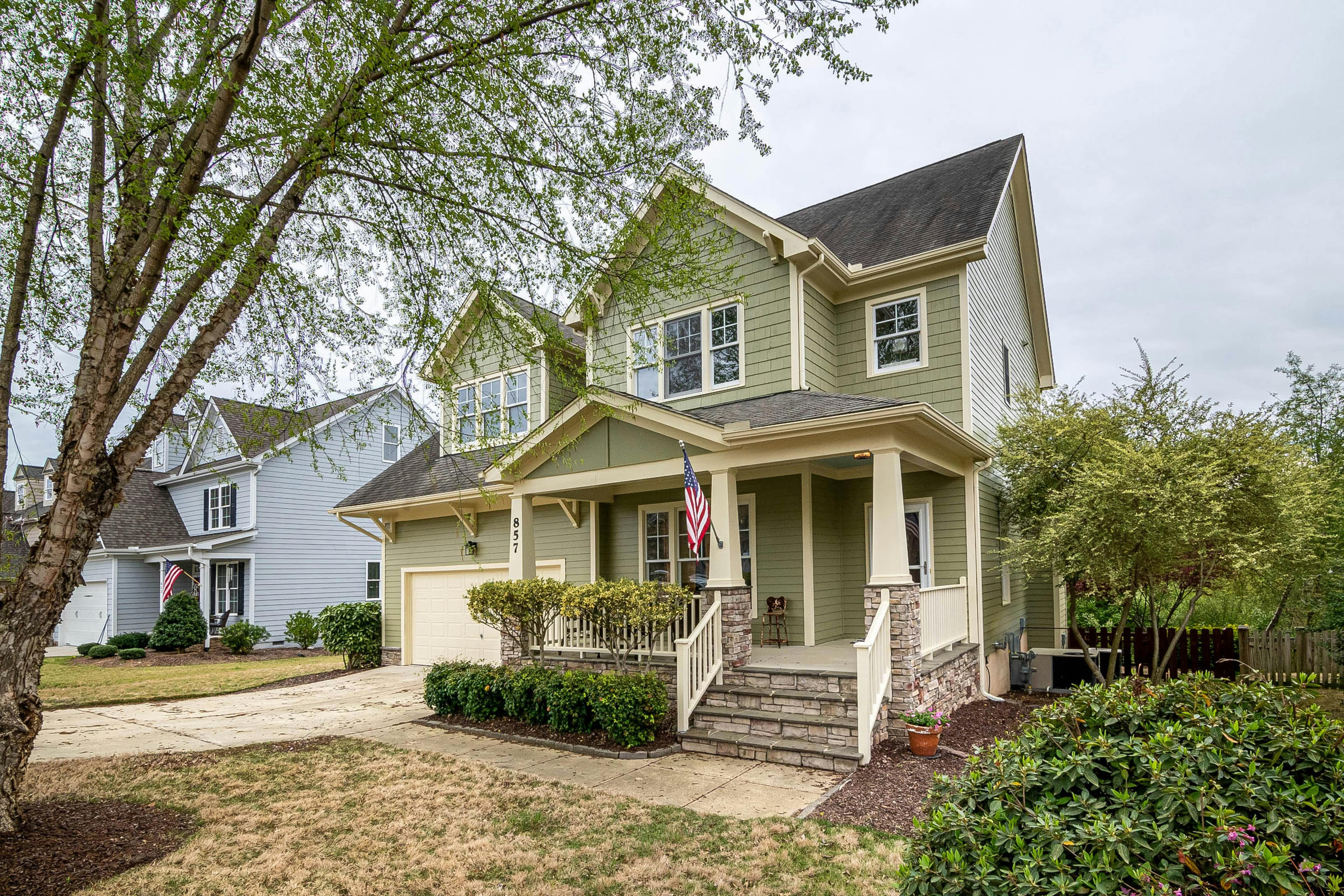 Craftsman home exterior with American flag and front porch